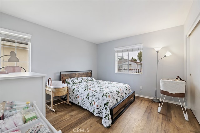 bedroom featuring baseboards and wood finished floors