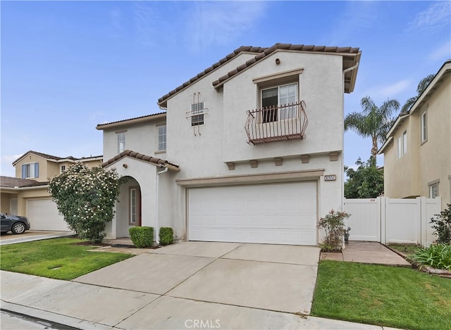 mediterranean / spanish-style house with fence, driveway, stucco siding, a garage, and a tile roof