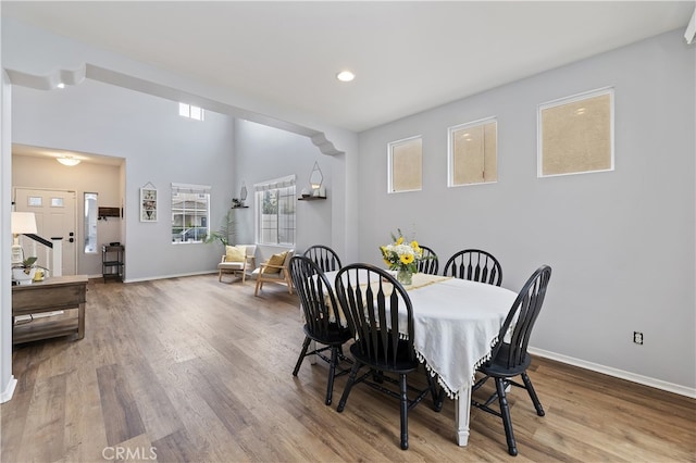 dining room featuring recessed lighting, baseboards, and wood finished floors