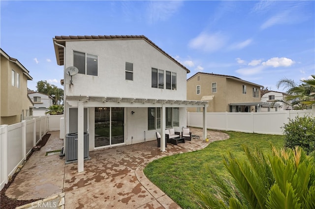 rear view of property featuring stucco siding, a fenced backyard, cooling unit, a yard, and a patio area