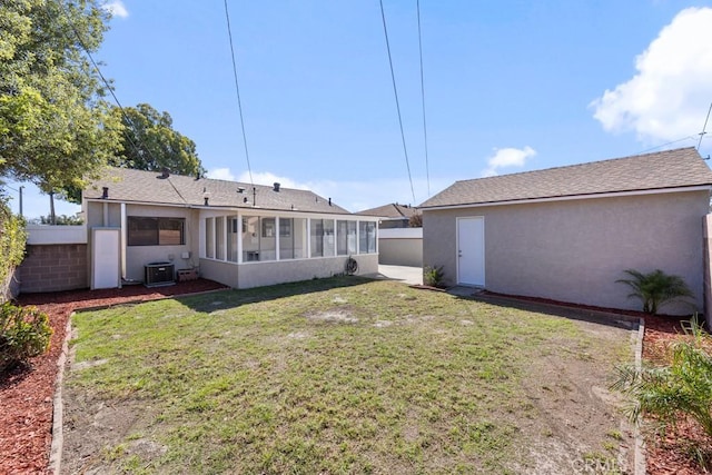 rear view of house featuring central AC unit, a sunroom, fence, and stucco siding