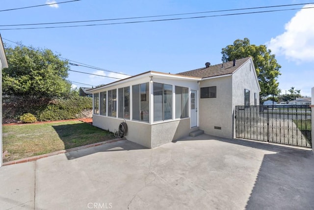 rear view of house with a patio, crawl space, a sunroom, and stucco siding