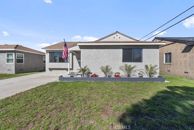 single story home with a front lawn, concrete driveway, and stucco siding