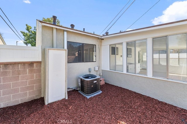 back of property with central AC and stucco siding