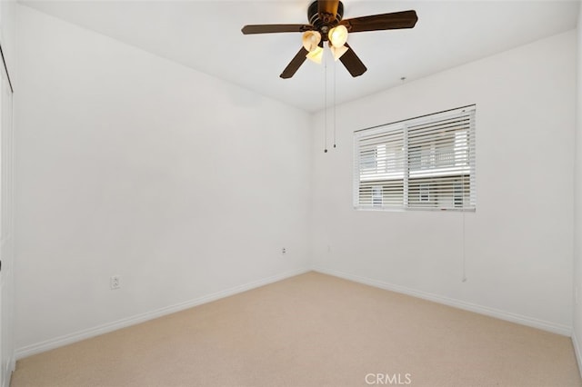 empty room with baseboards, light colored carpet, and ceiling fan