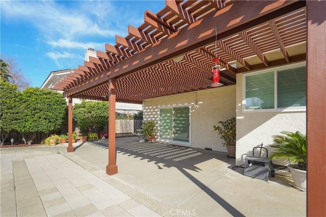 view of patio with a pergola and fence