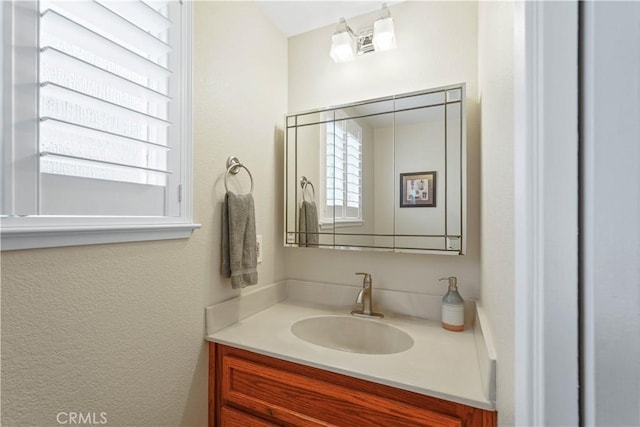 bathroom featuring plenty of natural light and vanity