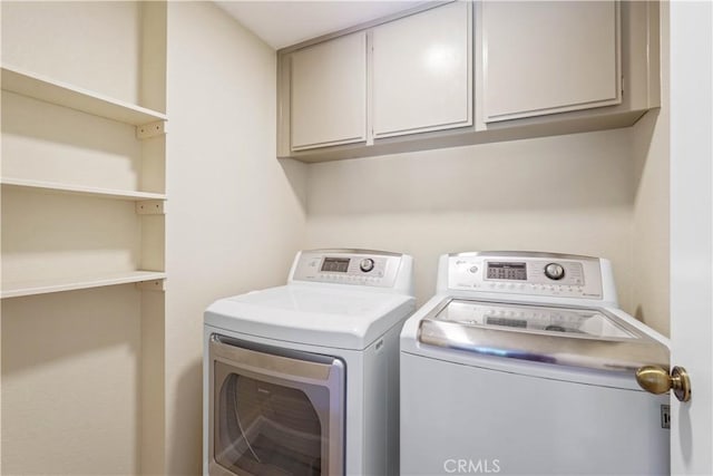 laundry room with cabinet space and separate washer and dryer