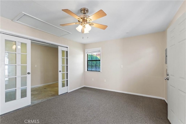 unfurnished room with ceiling fan, carpet, attic access, french doors, and baseboards