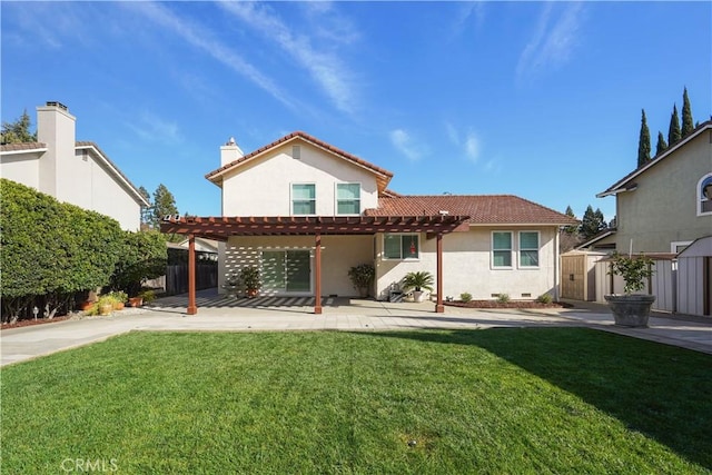 back of property with a tiled roof, a pergola, stucco siding, and fence