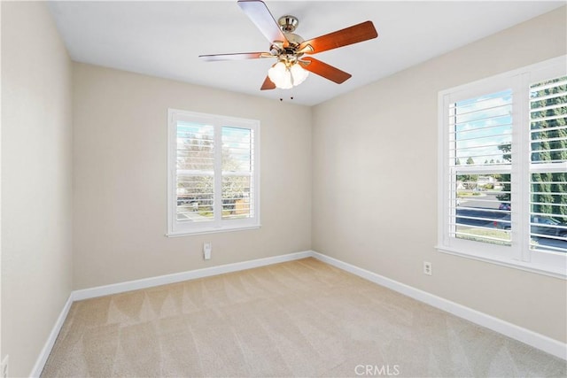 unfurnished room featuring a ceiling fan, baseboards, and carpet floors