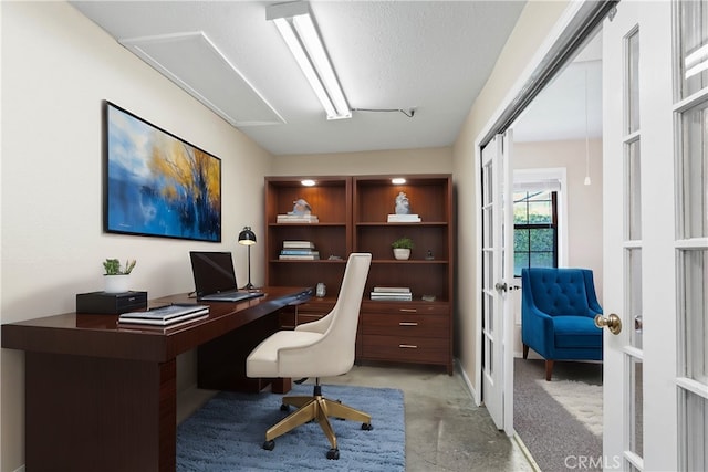 office space featuring french doors and a textured ceiling