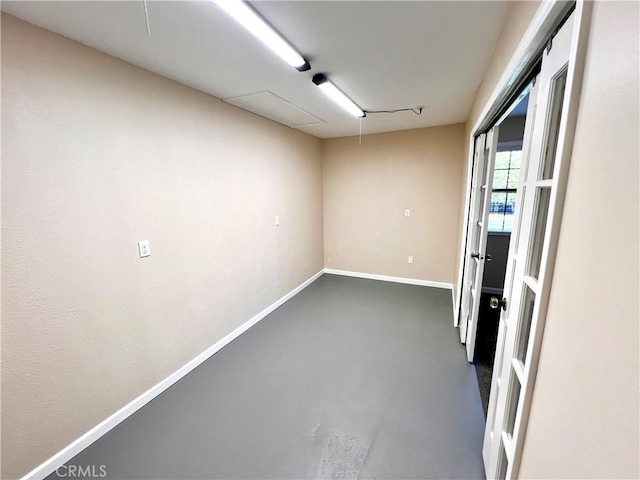 empty room with finished concrete floors and baseboards