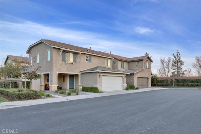 view of front facade with an attached garage and stucco siding