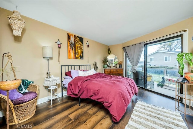 bedroom with access to outside, wood finished floors, and baseboards