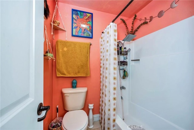 bathroom featuring toilet and baseboards