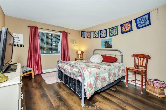 bedroom with baseboards and wood finished floors