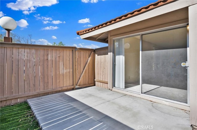 view of patio featuring a gate and fence