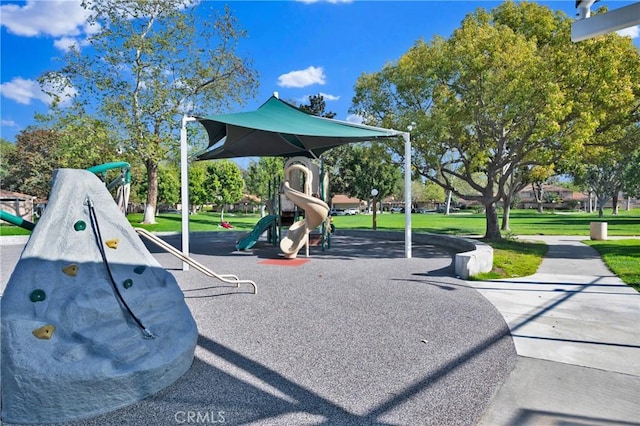 community jungle gym with a lawn