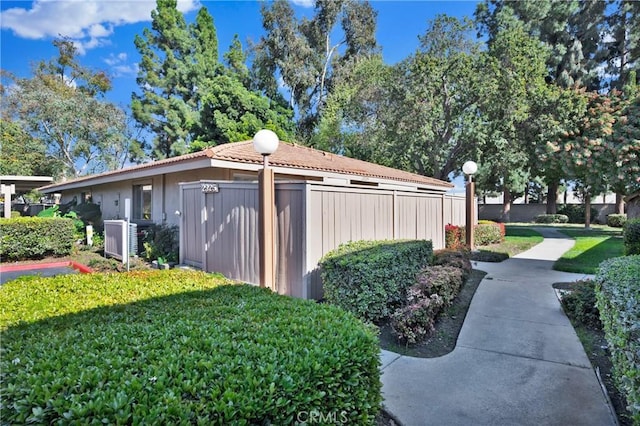 exterior space featuring central AC and fence