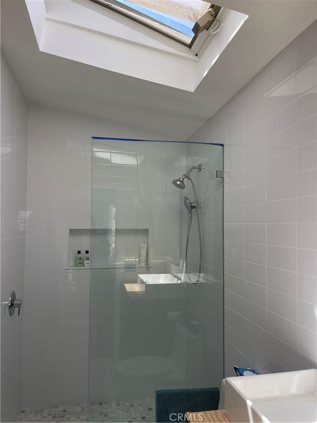 full bathroom with a skylight and a walk in shower