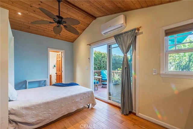 bedroom featuring an AC wall unit, light wood-style floors, multiple windows, and access to exterior