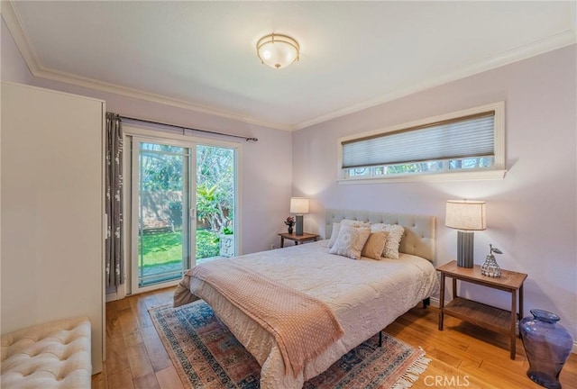 bedroom featuring ornamental molding, access to outside, and light wood-style floors