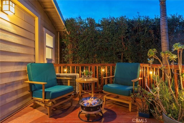 wooden terrace with an outdoor fire pit