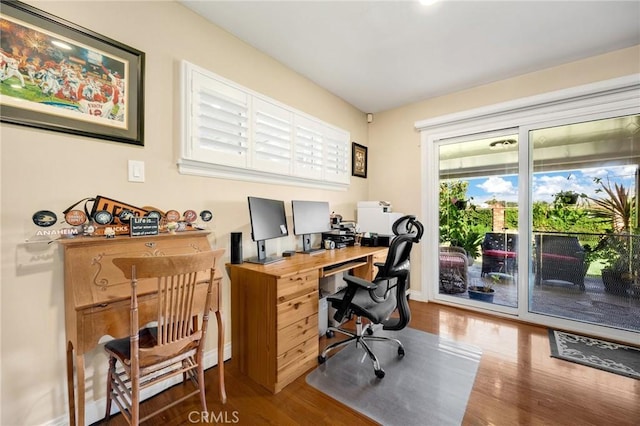 office featuring baseboards and wood finished floors