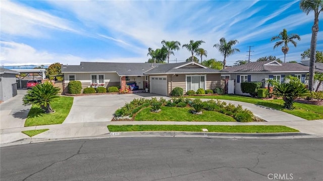 ranch-style house with a front lawn, an attached garage, and driveway