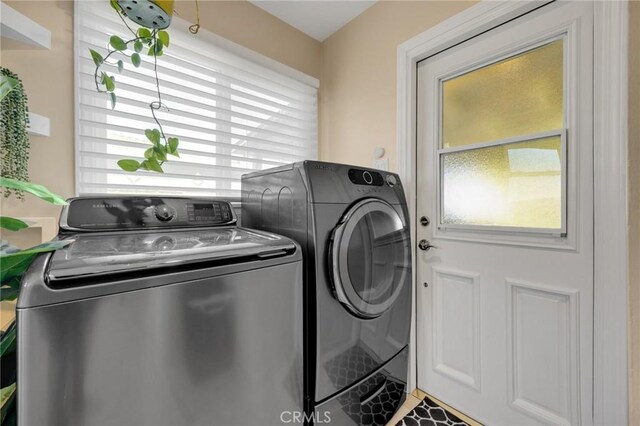 laundry area with washer and clothes dryer and laundry area