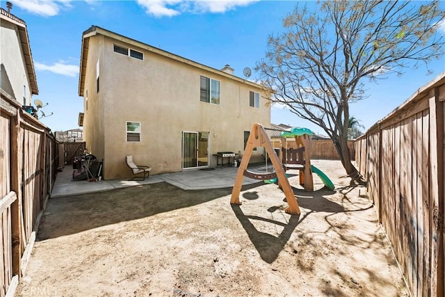 view of jungle gym featuring a patio area and a fenced backyard