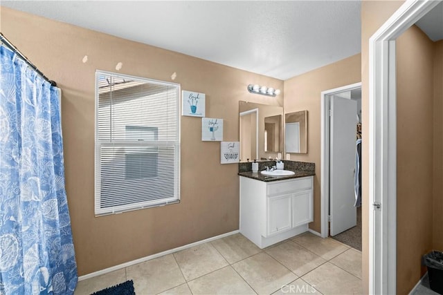 bathroom featuring tile patterned flooring, a shower with shower curtain, vanity, and baseboards