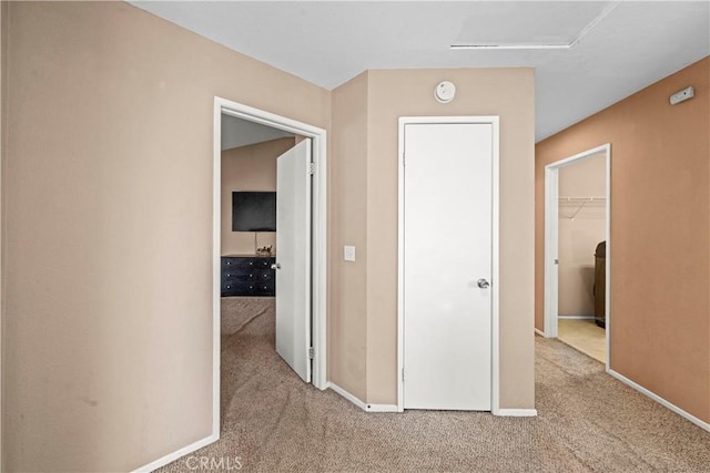 hall featuring carpet floors and baseboards