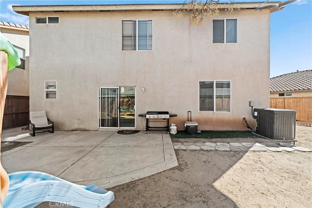 back of house featuring a patio, cooling unit, and stucco siding