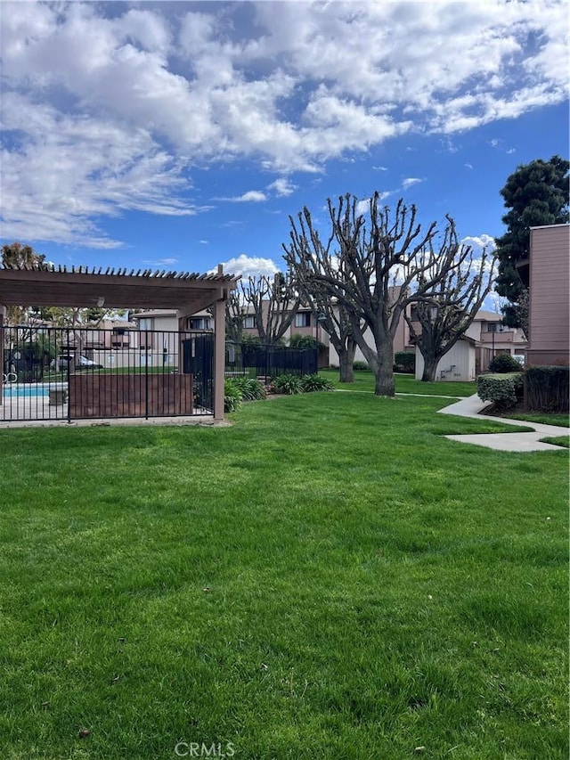 view of yard featuring a fenced in pool and fence