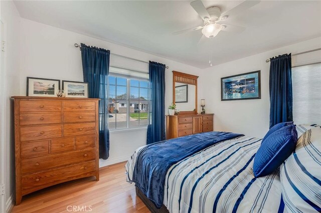 bedroom with a ceiling fan and light wood finished floors