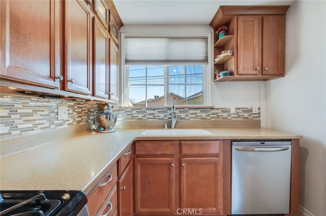 kitchen with brown cabinetry, appliances with stainless steel finishes, a sink, light countertops, and backsplash