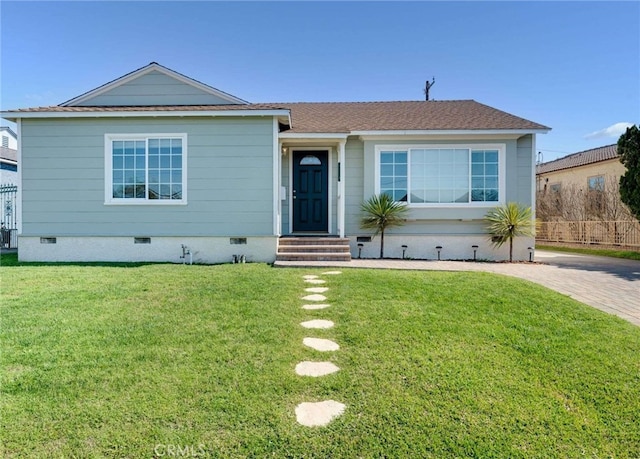 view of front of property with decorative driveway, roof with shingles, entry steps, crawl space, and a front lawn