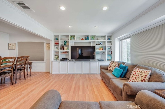 living area featuring light wood finished floors, recessed lighting, visible vents, and ornamental molding