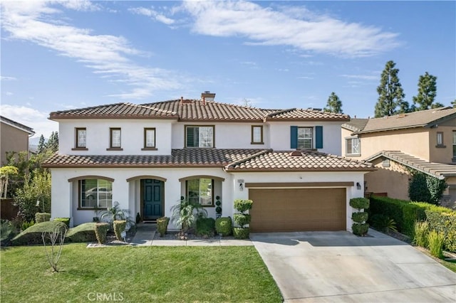 mediterranean / spanish-style house with a chimney, stucco siding, an attached garage, a front yard, and driveway