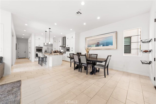 dining room with recessed lighting, visible vents, and baseboards