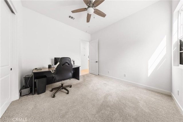 carpeted office with visible vents, ceiling fan, and baseboards