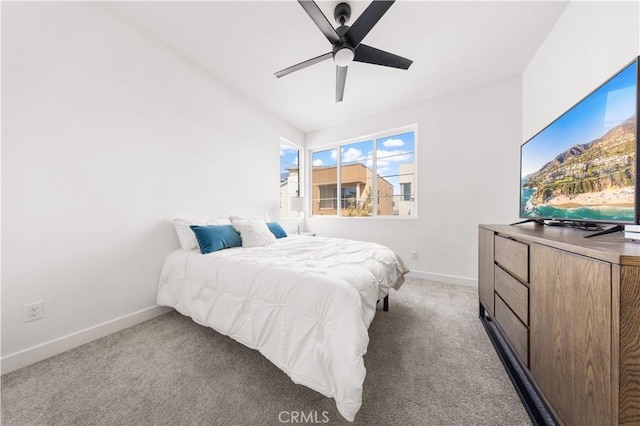 carpeted bedroom with a ceiling fan and baseboards