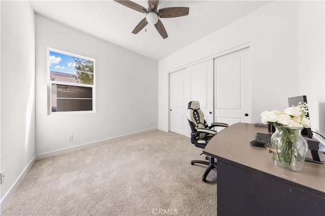 office space featuring carpet flooring, ceiling fan, and baseboards