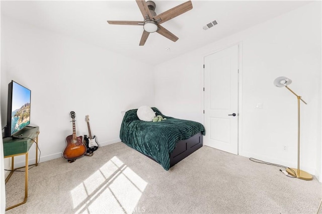 carpeted bedroom with visible vents, ceiling fan, and baseboards