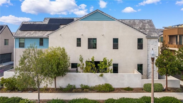 view of property exterior with fence and stucco siding