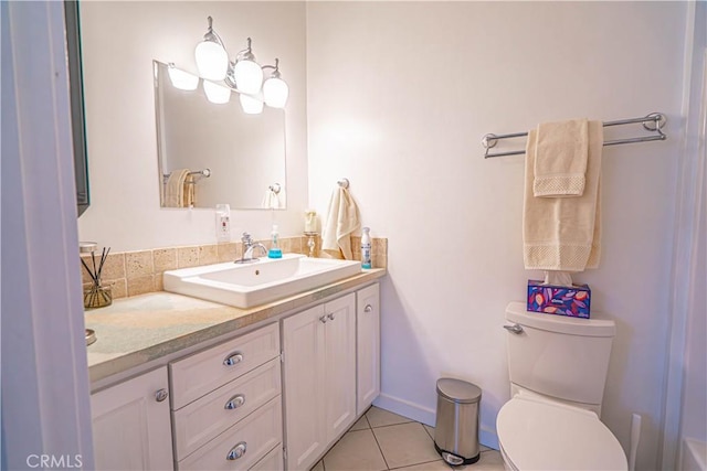 bathroom with toilet, tile patterned flooring, baseboards, and vanity