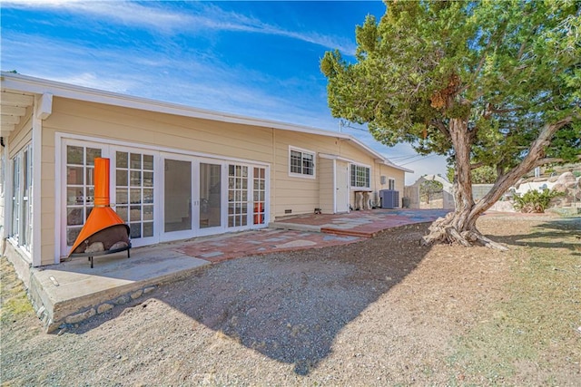 back of house with a patio area, central AC, and french doors