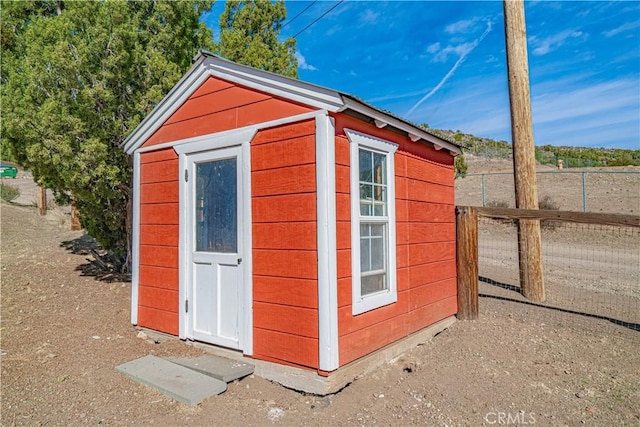 view of shed with fence